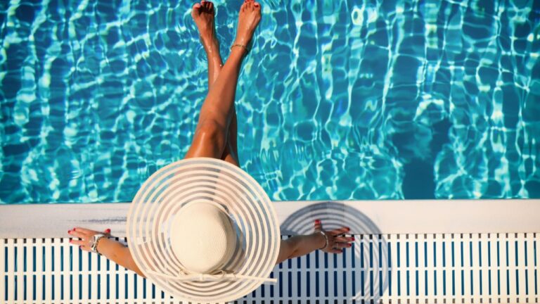 Woman relaxing by a pool after booking her Fort Myers vacation rental on FtMyersRents.com