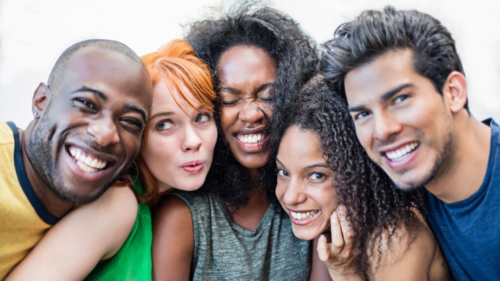 Group of smiling friends close together representing community connection in Fort Myers