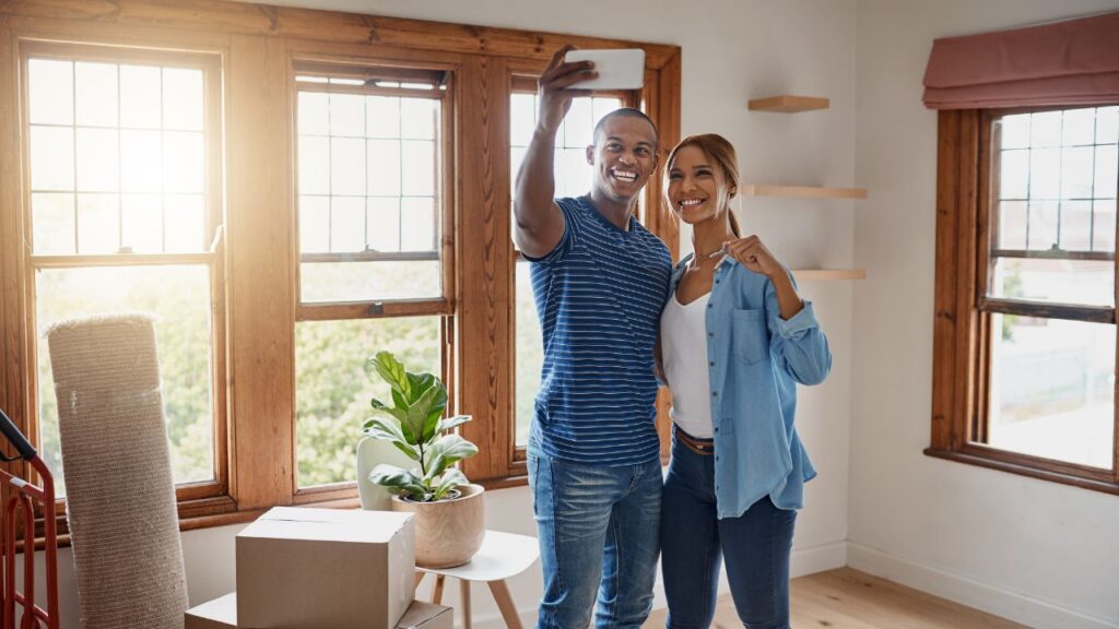 Happy first-time homebuyers taking a selfie after moving into their new Southwest Florida home