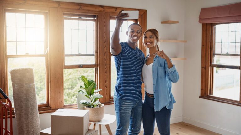 Happy first-time homebuyers taking a selfie after moving into their new Southwest Florida home