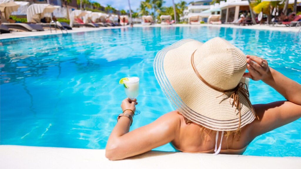 Woman relaxing by a resort-style pool, symbolizing tourism’s influence on the Southwest Florida rental market