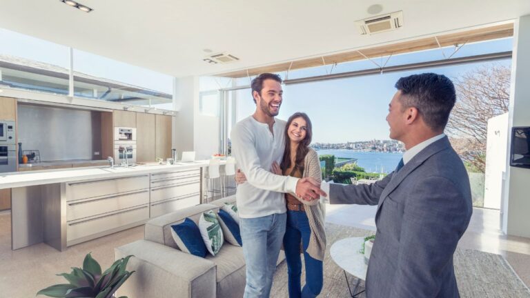 Couple meeting with a buyer’s agent in Fort Myers inside a modern waterfront home