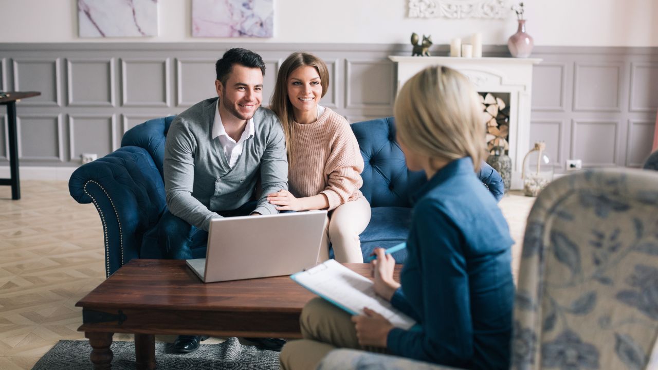 Couple meeting with the best real estate agent in Fort Myers to discuss buying a home