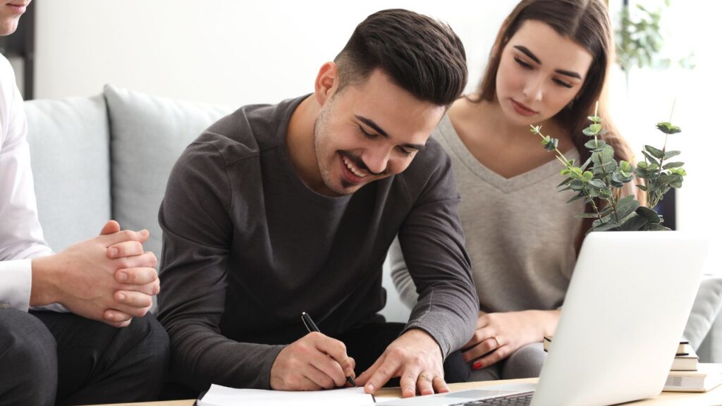 Young couple meeting with a Fort Myers real estate agent to discuss key questions before hiring