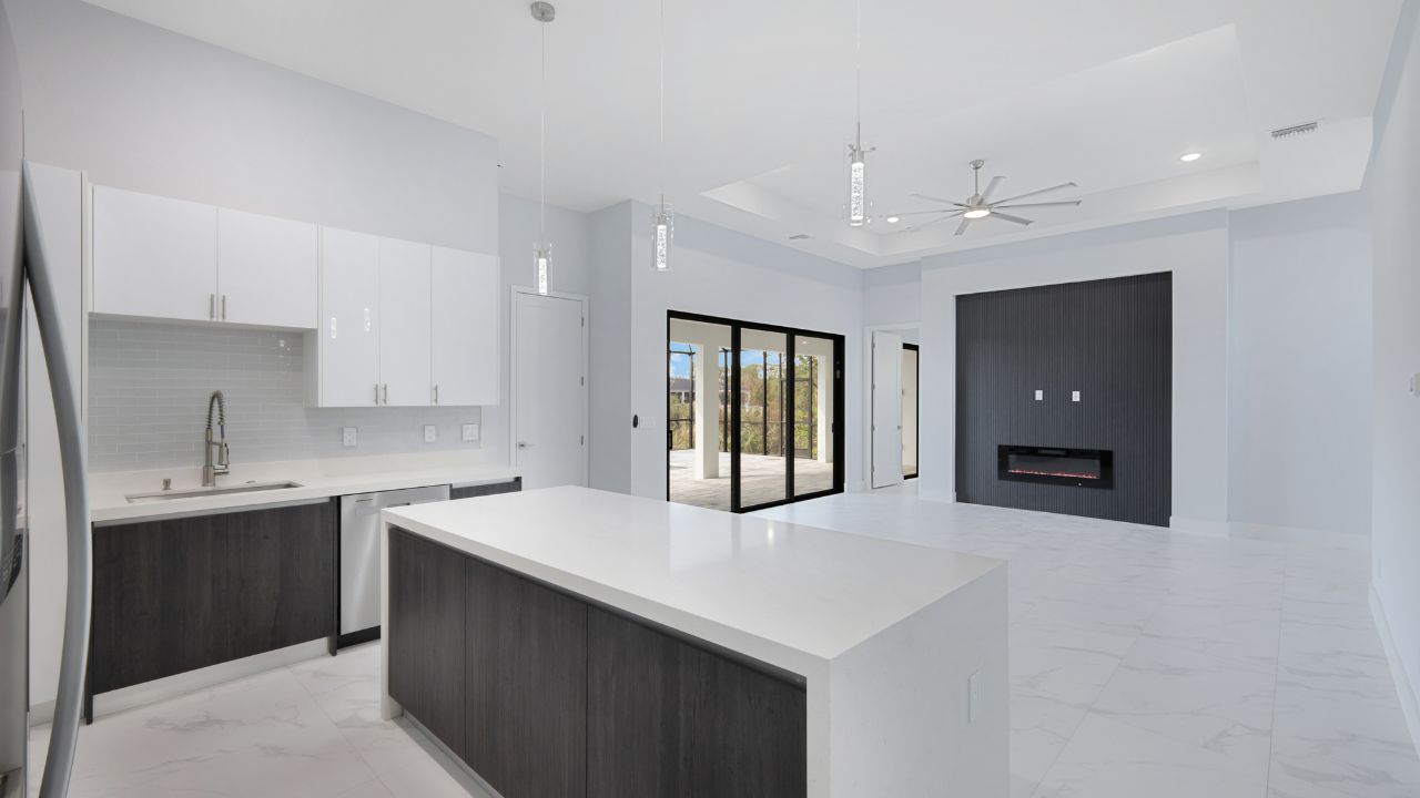 Modern kitchen and open living space in a Cape Coral new construction home