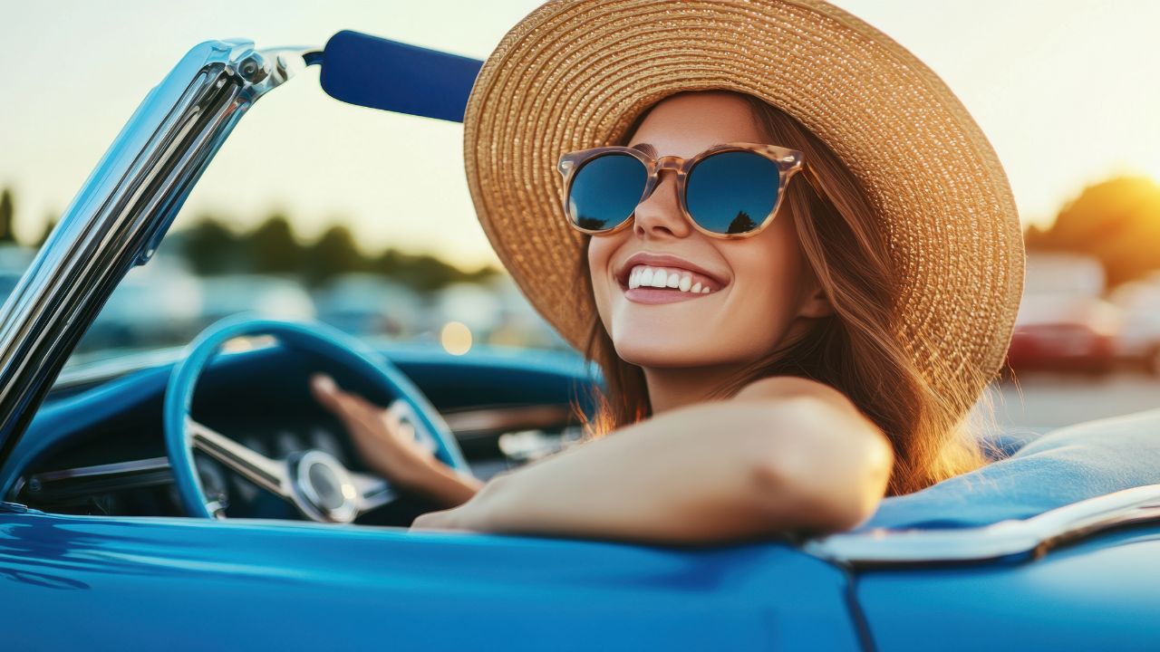 Smiling woman driving at sunset after recent Fort Myers road improvements