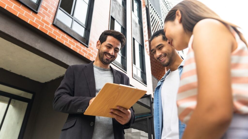 Real estate agent reviewing a new buyer agreement with clients in Southwest Florida