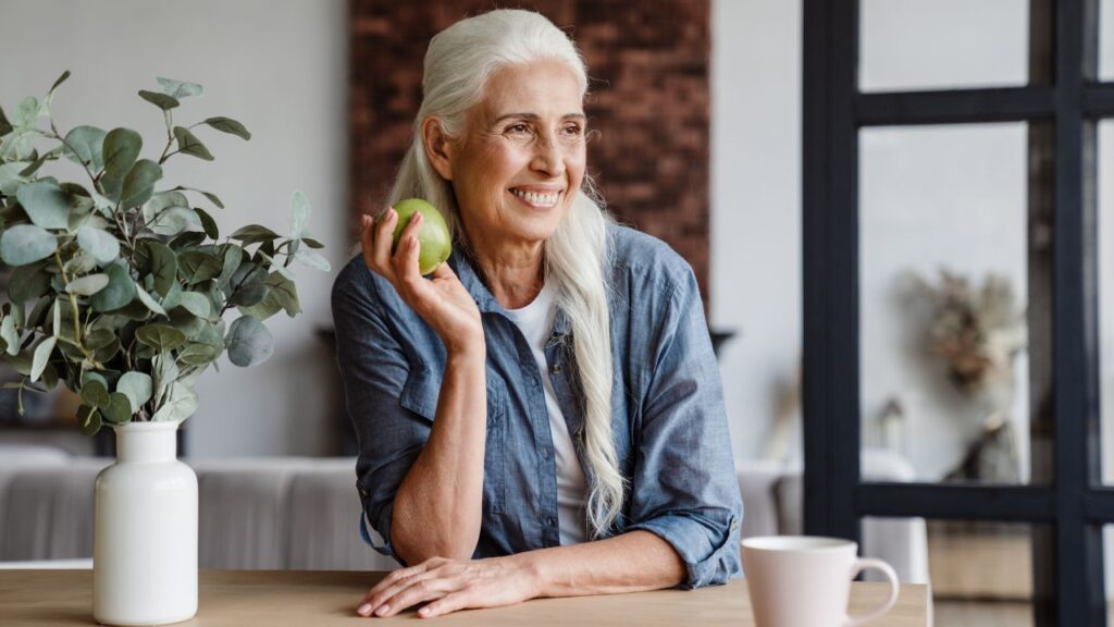 Smiling woman relaxing at home, representing the comfort and peace of mind of living near HealthPark Medical Center in Fort Myers