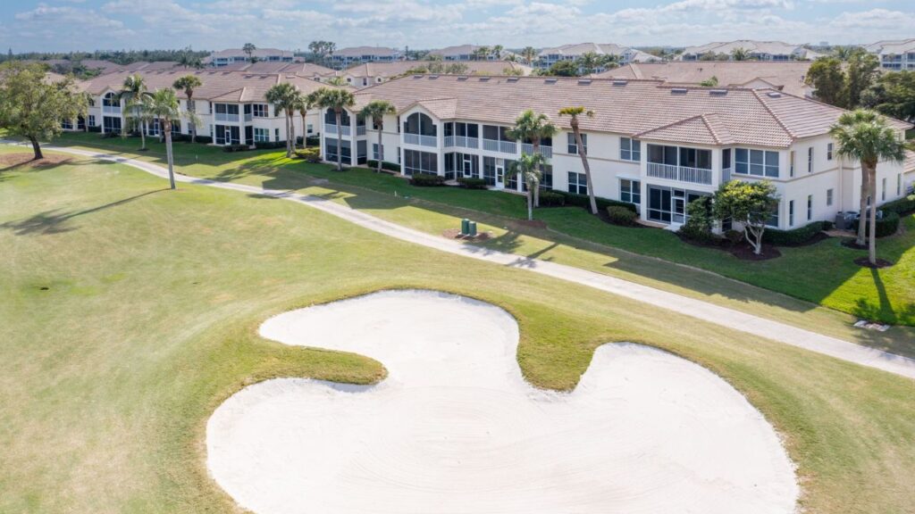 Wedgewood carriage homes at Lexington Country Club in Fort Myers overlooking a golf hole and sand bunker.