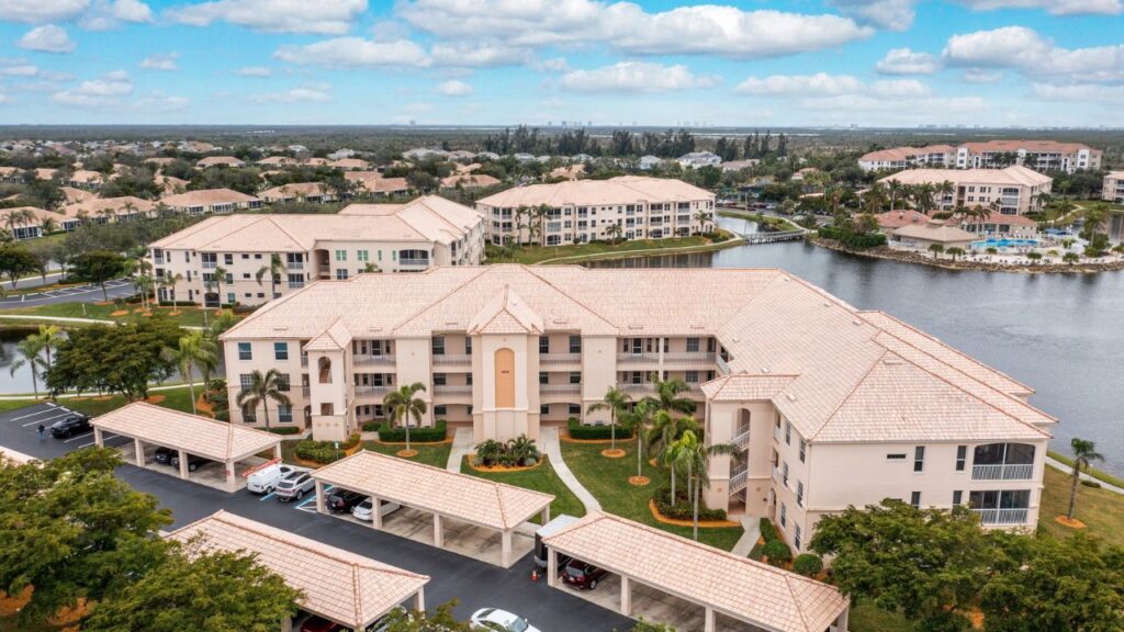 Aerial of Southmont Cove condos at Lexington Country Club in Fort Myers with lake and covered parking.