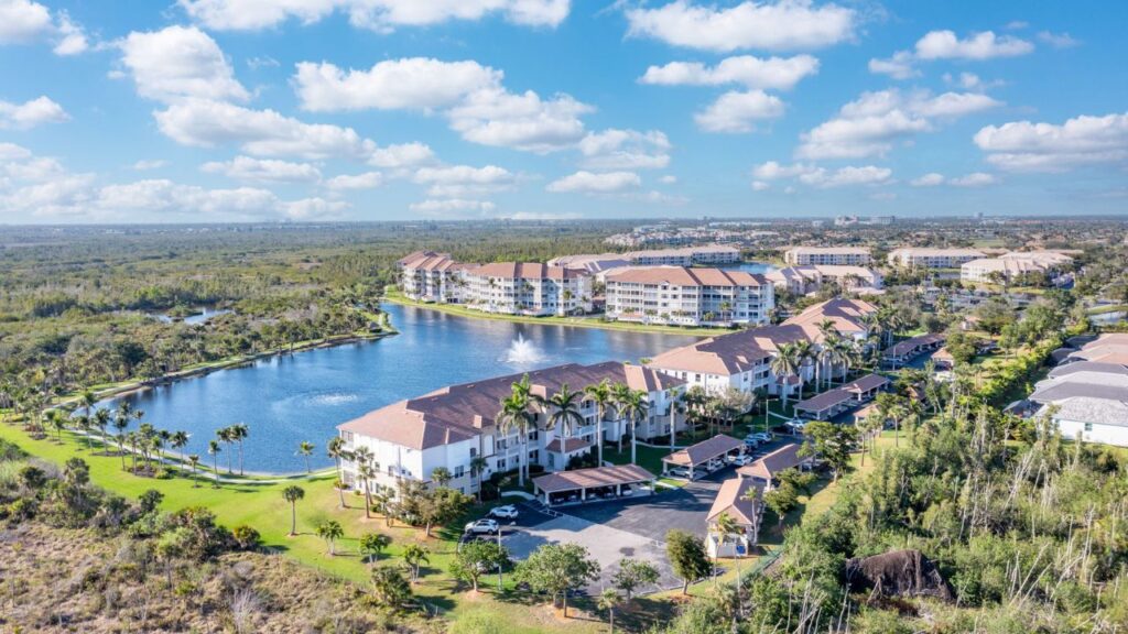 Aerial of Sutton Walk at Lexington Country Club in Fort Myers with lake, fountain, and preserve views.