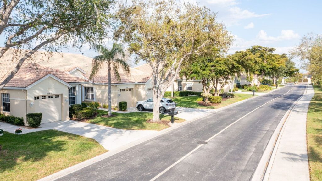 Tree-lined street of Sommerset Lexington Country Club villas on Stockbridge Drive in South Fort Myers.