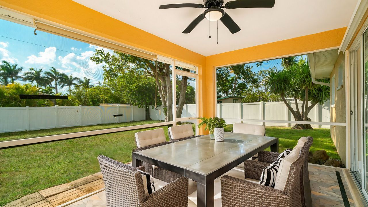 Screened patio with outdoor dining area at a Cape Coral Pelican neighborhood home