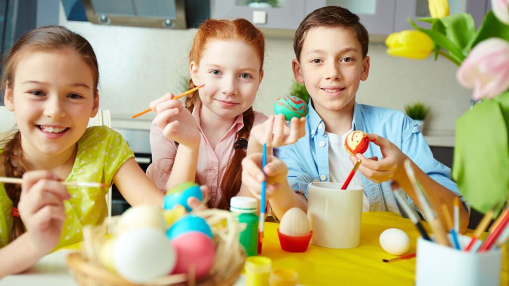 Children painting Easter eggs at a table for Easter events in Southwest Florida 2025