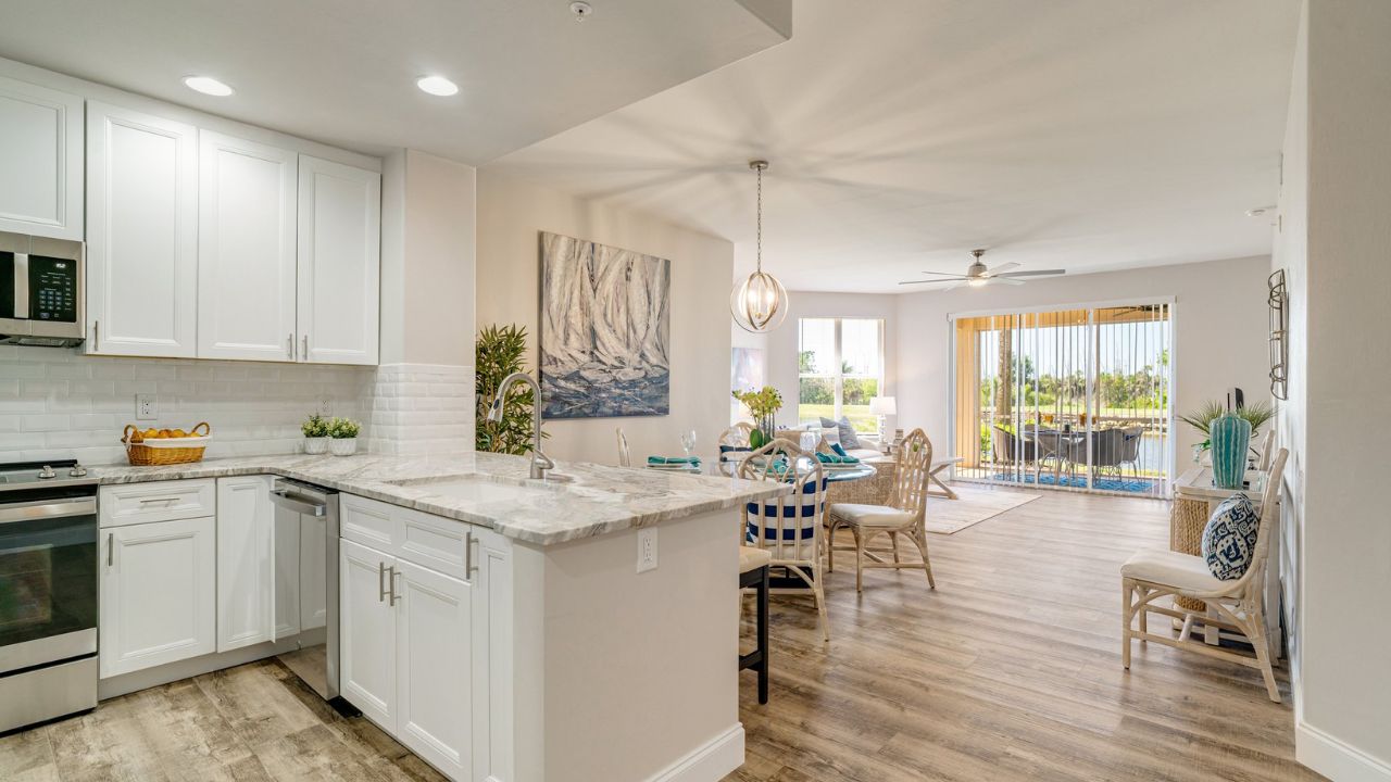 First-floor condo at Lexington Country Club overlooking a golf course and lake, showing the renovated interior with bright living area and lake view