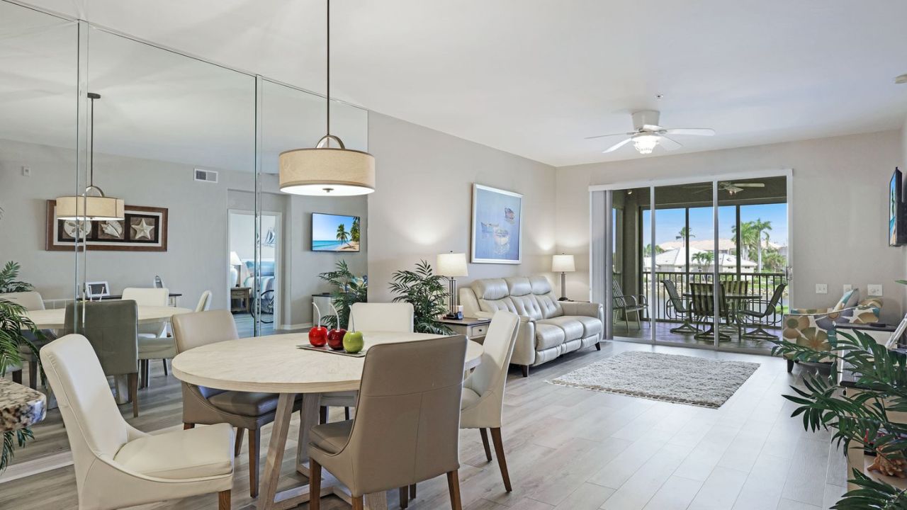 Bright living and dining area inside a Southmont Cove condo with sliding doors opening to a screened lanai