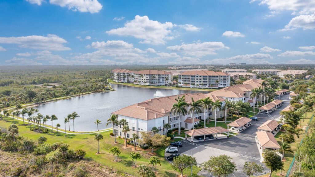 Aerial view of Sutton Walk lakefront condo buildings in Fort Myers surrounding a large lake