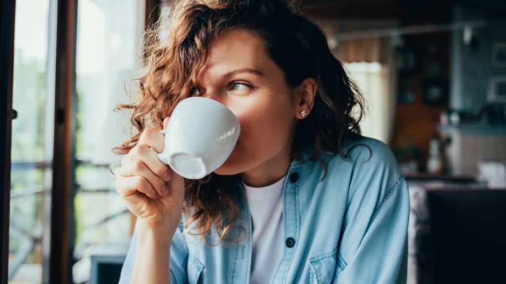 Woman enjoying a cup of coffee at a café for Wawa Day free coffee in Fort Myers 2025
