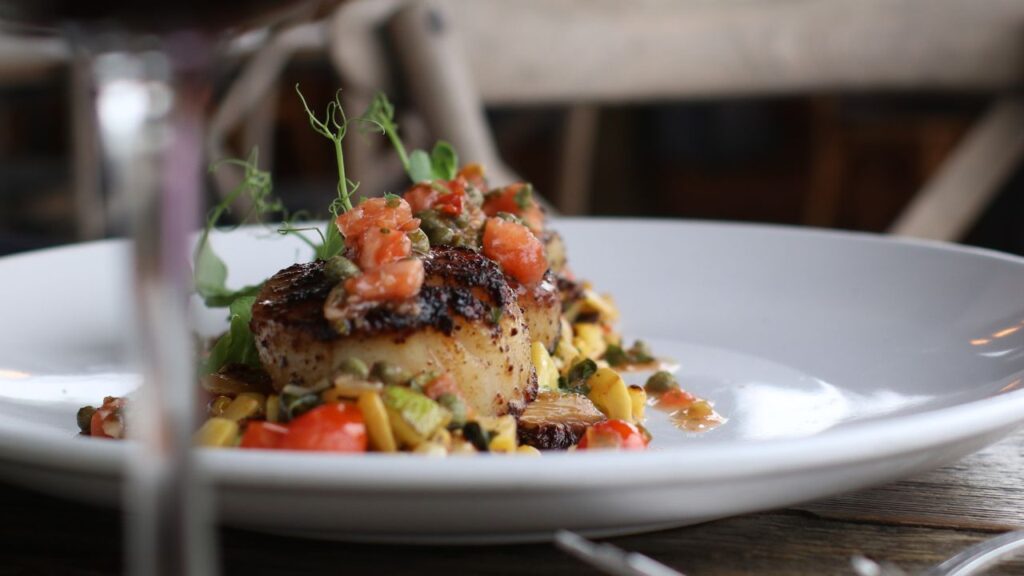 Seared scallops topped with tomato relish at Blossom & Brie in North Fort Myers