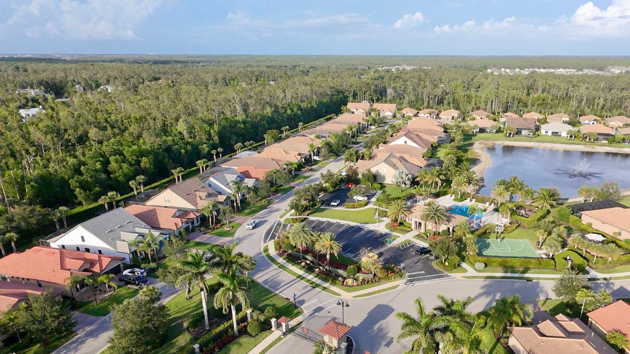 Aerial view of Camden Square community in Fort Myers with homes, lake, and clubhouse, representing a Camden Square Fort Myers home