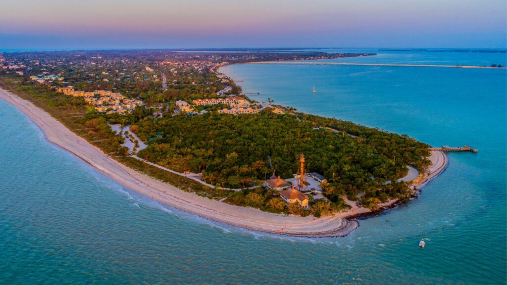Aerial view of Sanibel Island and the Sanibel Lighthouse at sunrise, representing the Lee County housing market May 2025
