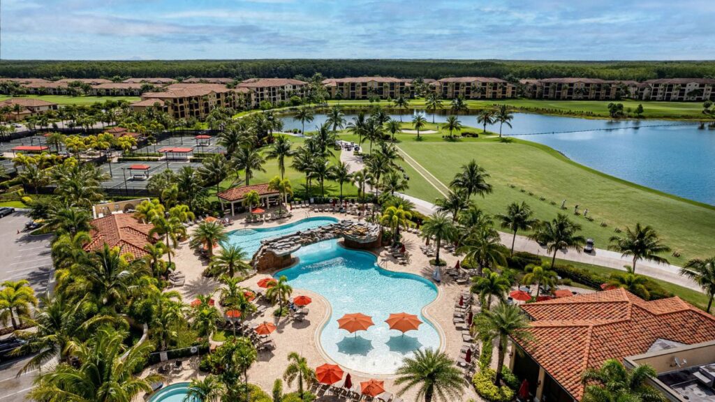 Aerial view of the resort-style pool, clubhouse, and golf course at Bonita National Golf & Country Club