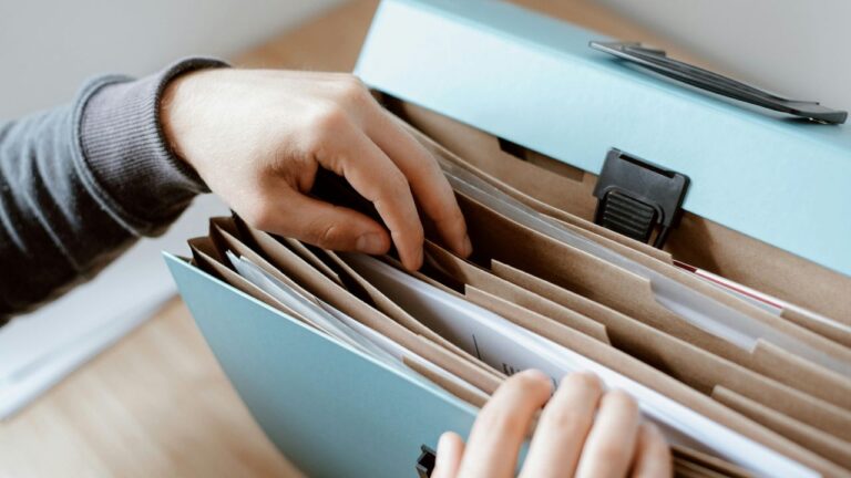 Hurricane preparedness documents organized in a portable file folder