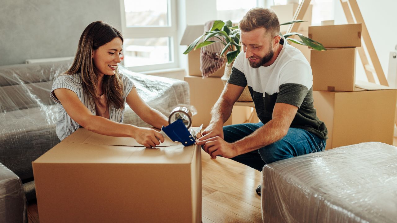 couple packing moving boxes after selling their home using a real estate strategy to help sellers