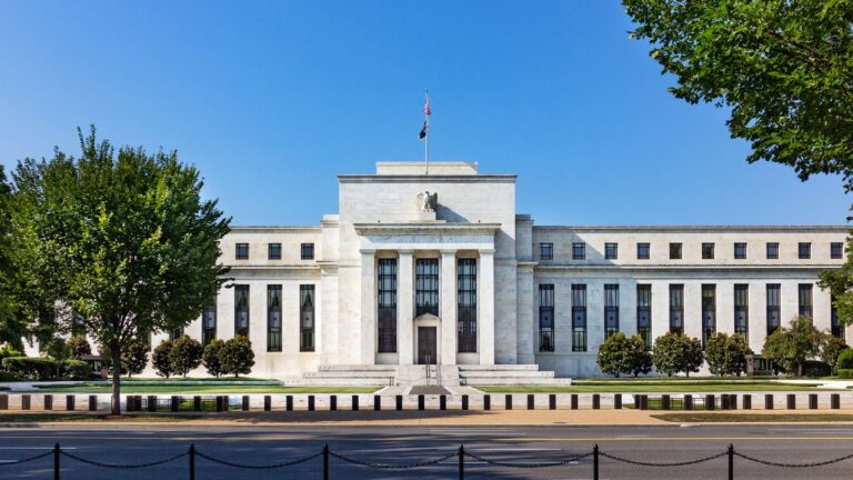 Front view of a government building with tall columns, representing the impact of federal policy on Southwest Florida housing