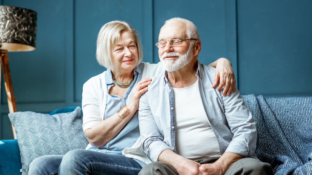 Senior couple sitting together while planning their move to Amavida at Lakes Park in Fort Myers