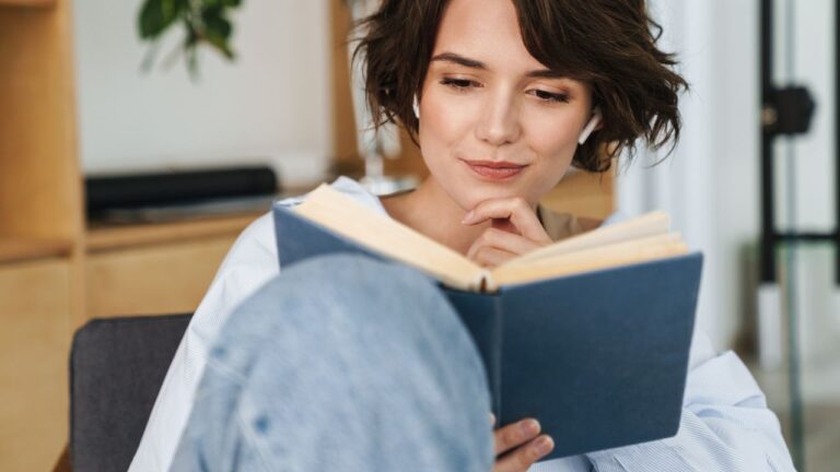 Real estate agent studying professional development book during real estate training in Southwest Florida