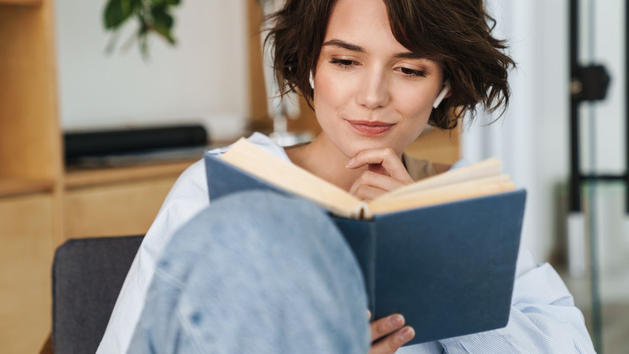 Real estate agent studying professional development book during real estate training in Southwest Florida