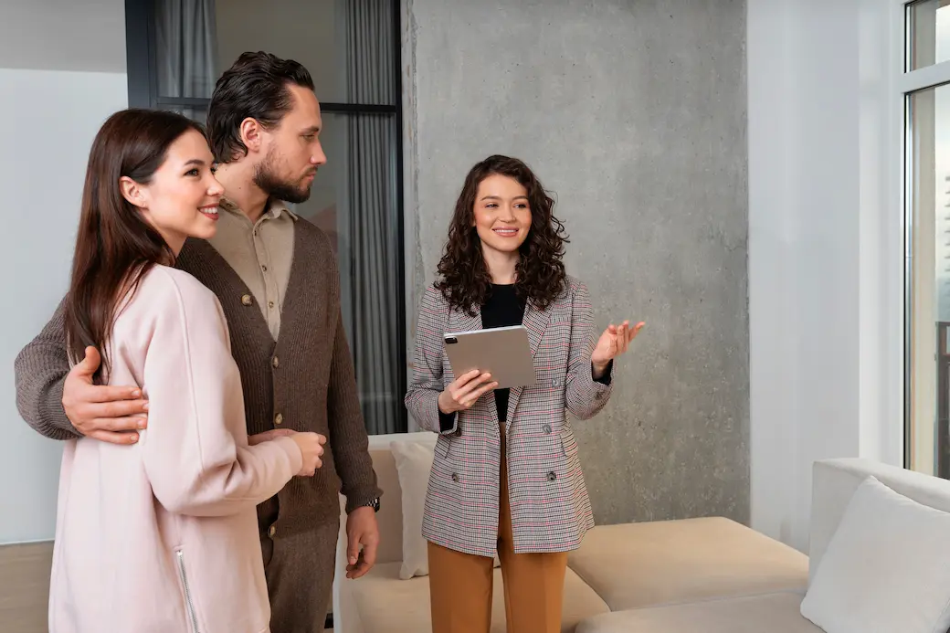 Home buyers meeting with a local real estate agent during a home showing