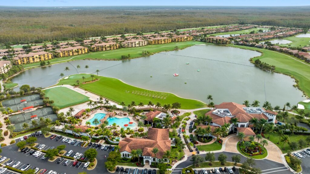 Aerial view of Bonita National Golf & Country Club with lake, golf course, clubhouse, and resort amenities in Bonita Springs Florida.