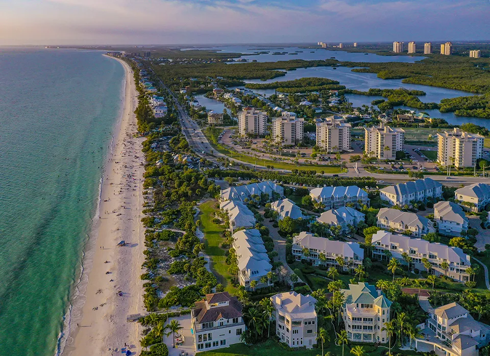 Aerial view of Barefoot Beach Preserve, Bonita Beach, and Beach and Tennis Club in Bonita Springs, FL, highlighting the area's pristine Gulf coastline