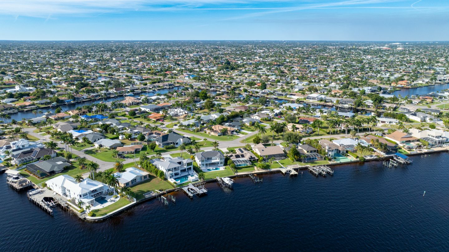 Aerial view of Cape Coral waterfront homes and canals, showing neighborhood layout for the Cape Coral real estate market.