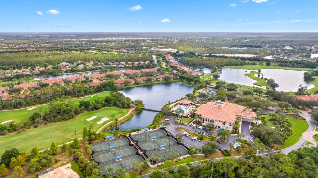 Aerial view of Grandezza in Estero, Florida with golf course, clubhouse, lakes, and tennis courts.