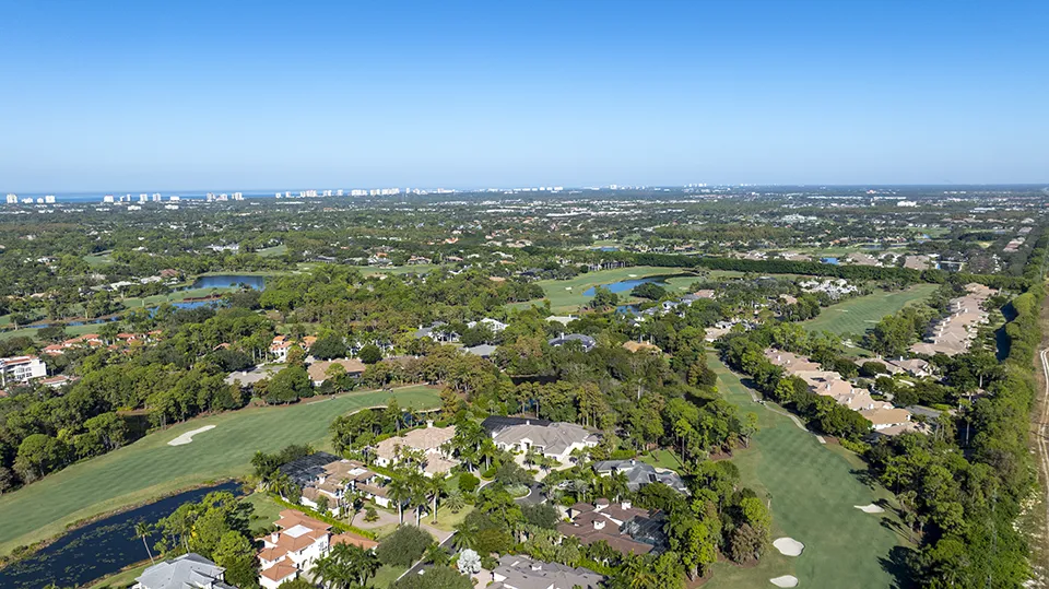 Aerial view of luxury custom estates and private golf course at Grey Oaks, a gated equity country club community with homes for sale in Naples, FL