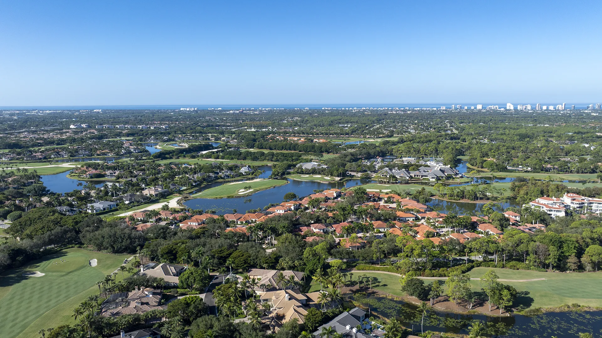 Aerial view of Grey Oaks in Naples, FL, an exclusive private country club community with homes for sale near the Gulf of Mexico, featuring championship golf courses and luxury estates