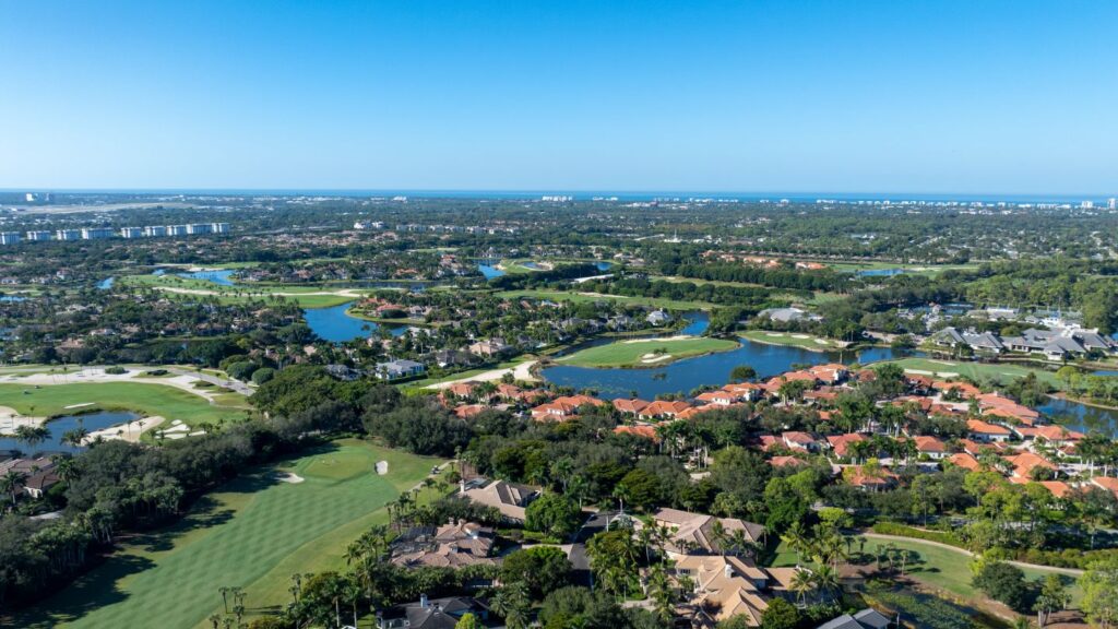 Aerial view of Grey Oaks in Naples with golf course, luxury homes, and preserve areas.