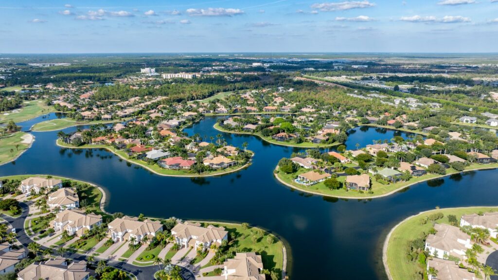 Aerial view of Lely Resort in Naples with golf course neighborhoods and lakefront homes.