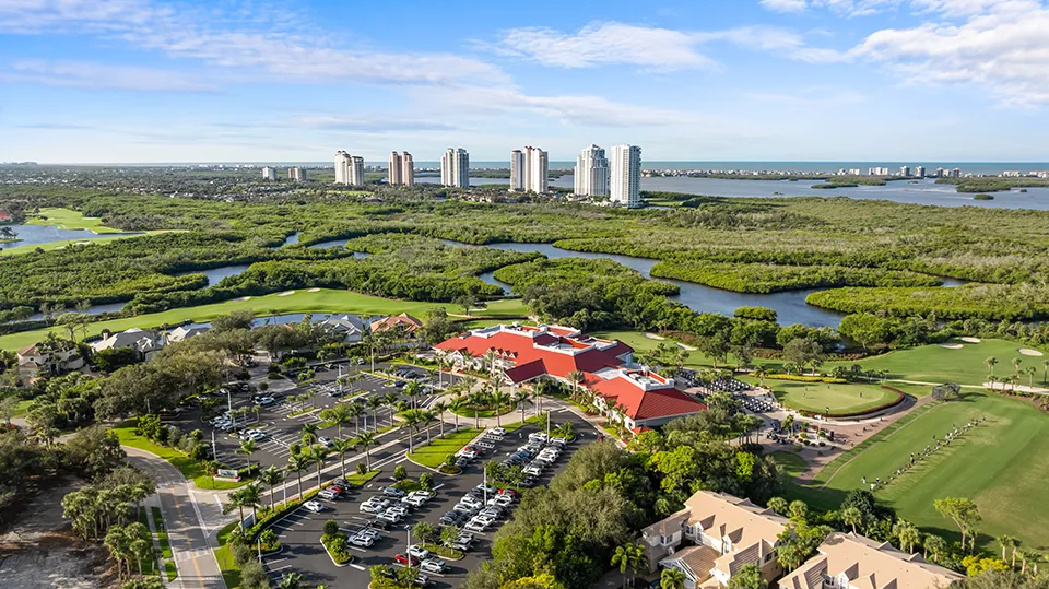 Aerial view of Pelican's Nest Golf Club in Pelican Landing, Bonita Springs, FL, featuring the 36-hole Tom Fazio-designed championship course, lakes, preserves, and surrounding luxury homes for sale in the gated community.