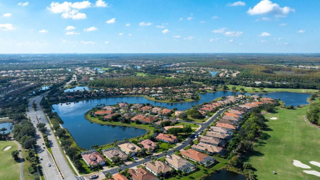 Aerial view of Pelican Preserve in Fort Myers featuring lakes, golf holes, and residential neighborhoods.