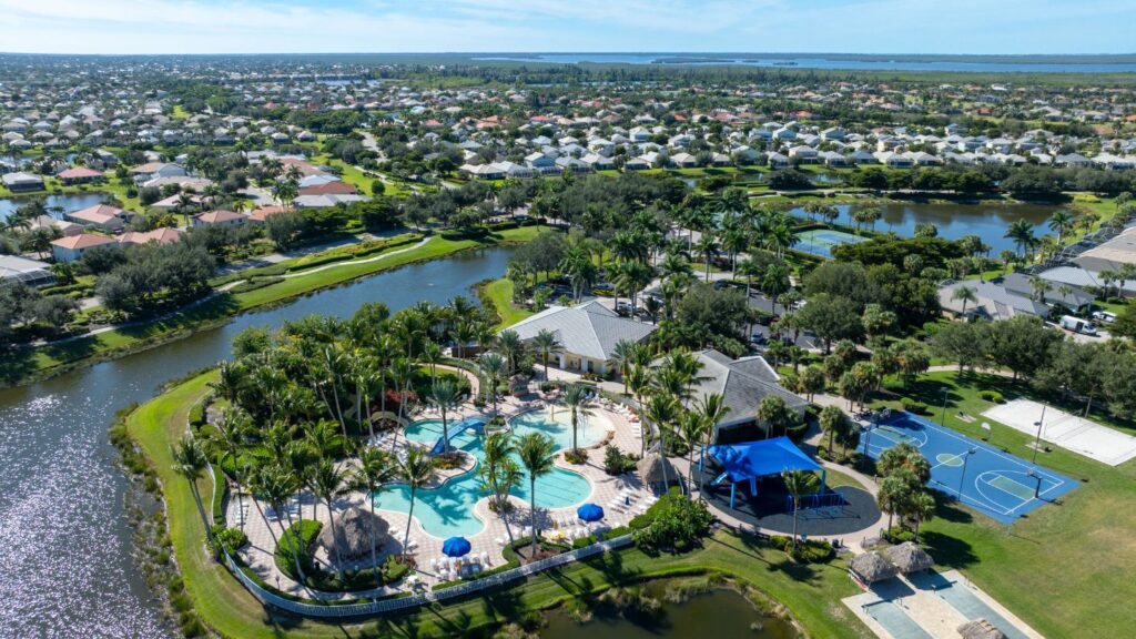 Aerial view of Sandoval in Cape Coral with community pool, lakes, and surrounding homes.