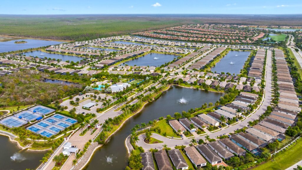 Aerial view of Seasons at Bonita with lakes, newer single-family homes, community amenities, and surrounding nature.