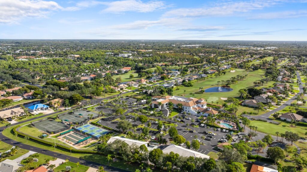 Aerial view of Spanish Wells Golf & Country Club in Bonita Springs with fairways, lakes, and surrounding homes.