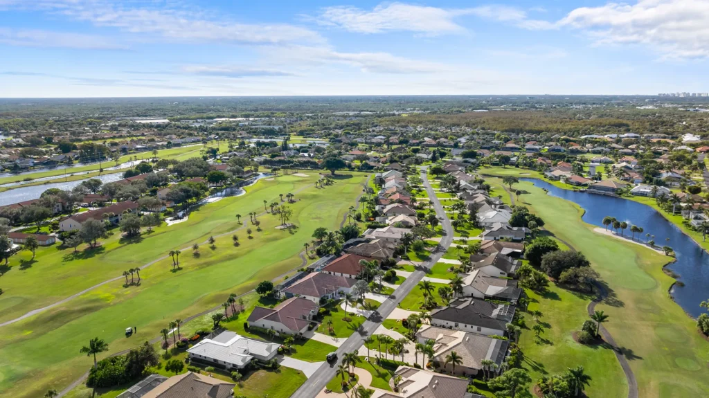 Aerial view of Spanish Wells Golf & Country Club, a gated community with homes for sale featuring the 27-hole championship golf course, lakes, and preserves in Bonita Springs, FL