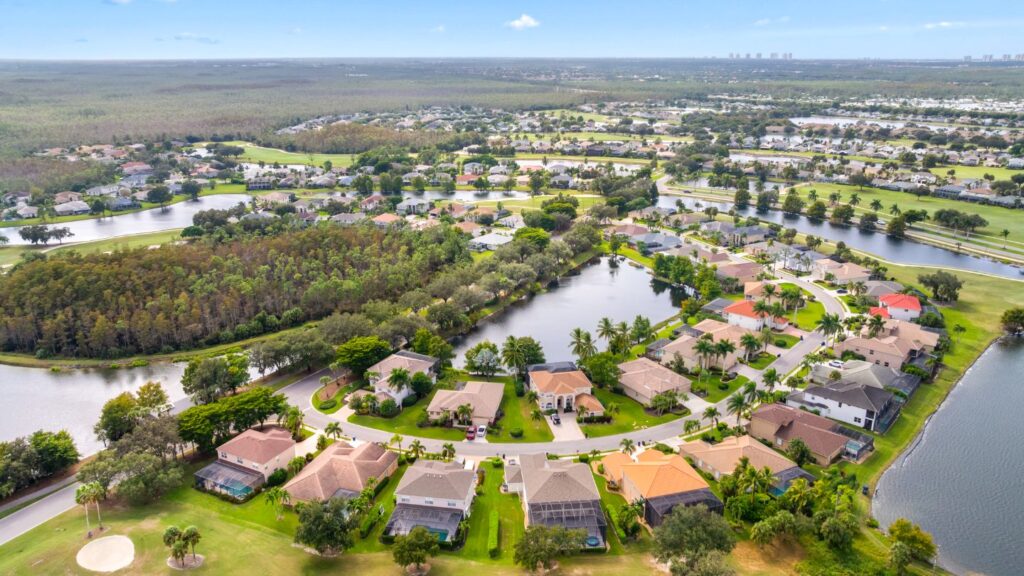 Aerial view of Stoneybrook in Estero featuring homes, golf course areas, and lake systems.