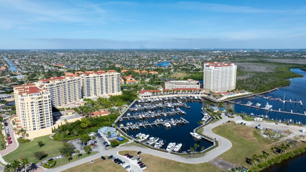 Aerial view of Tarpon Point Marina in Cape Coral with condos, waterfront homes, and marina.