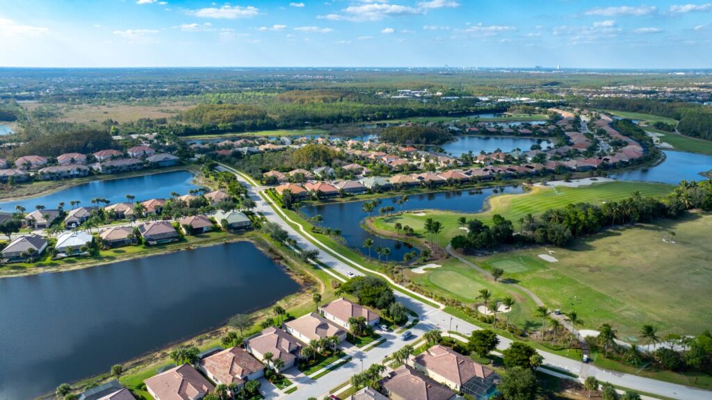 Aerial view of The Plantation in Fort Myers showing golf courses, lakes, and nearby residential streets.